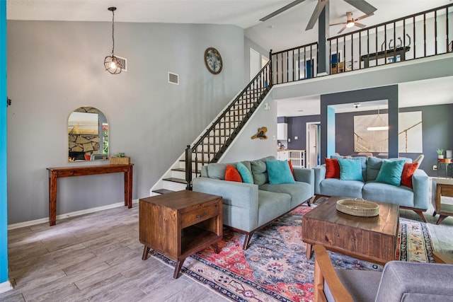 5210 Creek Shadows Dr, Houston, TX 77339 - living room featuring a ceiling fan, stairway, wood finished floors, and high vaulted ceiling
