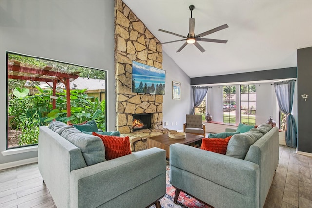 5210 Creek Shadows Dr, Houston, TX 77339 - living area with high vaulted ceiling, ceiling fan, wood finished floors, and a stone fireplace