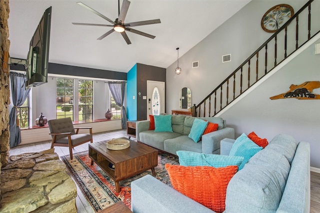 5210 Creek Shadows Dr, Houston, TX 77339 - living room featuring high vaulted ceiling, stairway, wood finished floors, a ceiling fan, and arched walkways