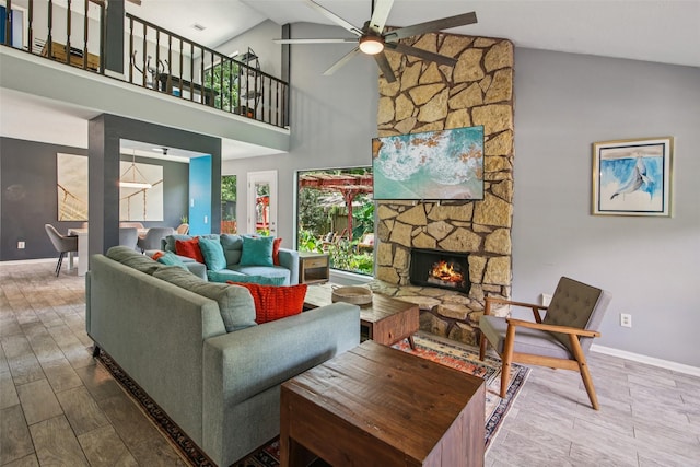 5210 Creek Shadows Dr, Houston, TX 77339 - living room featuring a ceiling fan, a fireplace, wood finished floors, and high vaulted ceiling
