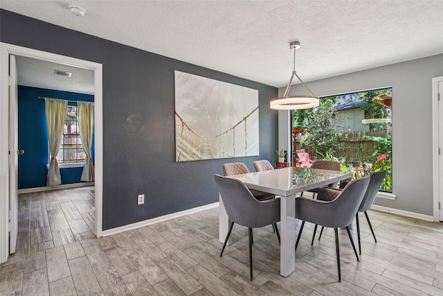 5210 Creek Shadows Dr, Houston, TX 77339 - dining space with wood finished floors and a textured ceiling