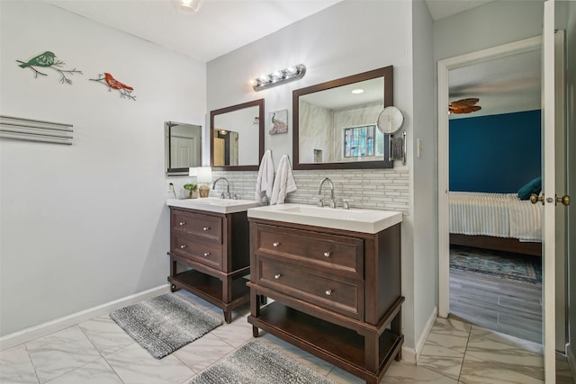 5210 Creek Shadows Dr, Houston, TX 77339 - ensuite bathroom with marble finish flooring, two vanities, and decorative backsplash