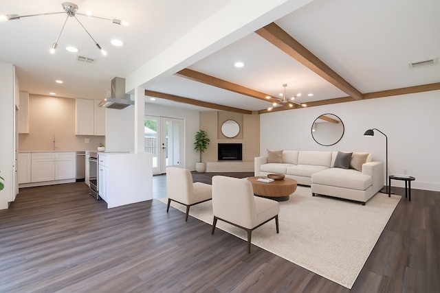10602 Tenneta Dr, Houston, TX 77099 - living area with a chandelier, beamed ceiling, dark wood-type flooring, recessed lighting, and a brick fireplace