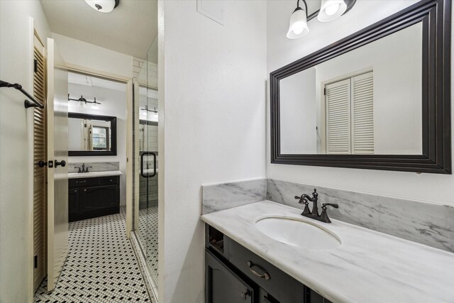 1881 Bering Dr Unit 83, Houston, TX 77057 - bathroom featuring a stall shower, vanity, and tile patterned floors