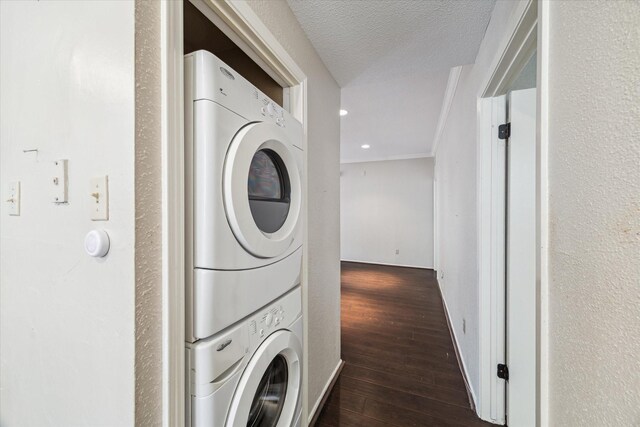 1881 Bering Dr Unit 83, Houston, TX 77057 - laundry room featuring stacked washer and clothes dryer, dark wood-style flooring, a textured ceiling, and crown molding