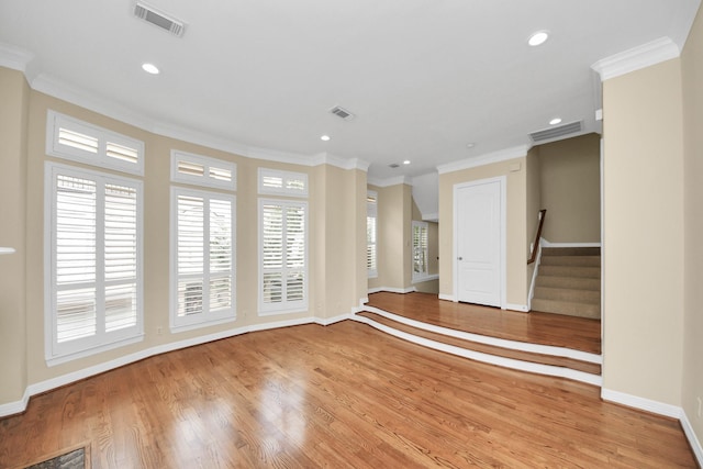 2930 Brompton Square Dr, Houston, TX 77025 - unfurnished room with crown molding, stairway, light wood-style floors, and recessed lighting