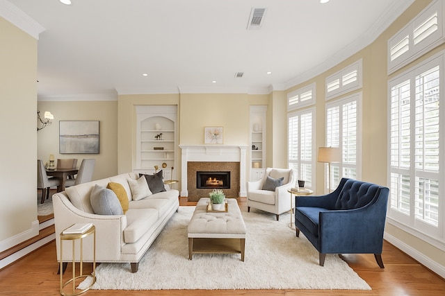 2930 Brompton Square Dr, Houston, TX 77025 - living room with plenty of natural light, ornamental molding, wood finished floors, a lit fireplace, and recessed lighting