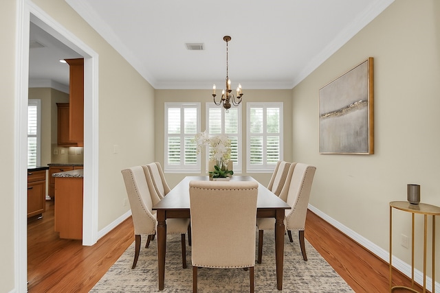 2930 Brompton Square Dr, Houston, TX 77025 - dining room featuring ornamental molding, a chandelier, and light wood finished floors