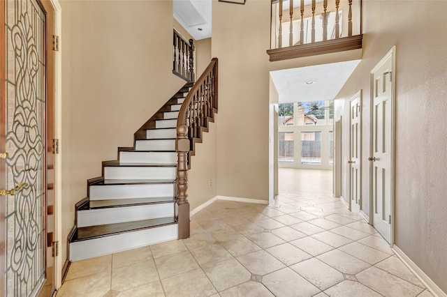12102 Moorcreek Dr, Houston, TX 77070 - entrance foyer with tile patterned floors, a towering ceiling, and stairs