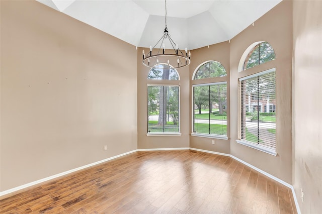 12102 Moorcreek Dr, Houston, TX 77070 - spare room featuring wood finished floors, a chandelier, and high vaulted ceiling