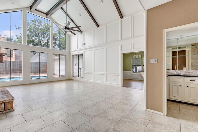 12102 Moorcreek Dr, Houston, TX 77070 - unfurnished living room with high vaulted ceiling, a decorative wall, beam ceiling, ceiling fan, and light tile patterned floors