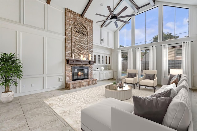 12102 Moorcreek Dr, Houston, TX 77070 - living area with high vaulted ceiling, ceiling fan, a brick fireplace, beamed ceiling, and light tile patterned floors
