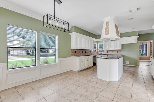 12102 Moorcreek Dr, Houston, TX 77070 - kitchen featuring dark countertops, white cabinetry, light tile patterned floors, wainscoting, and decorative backsplash