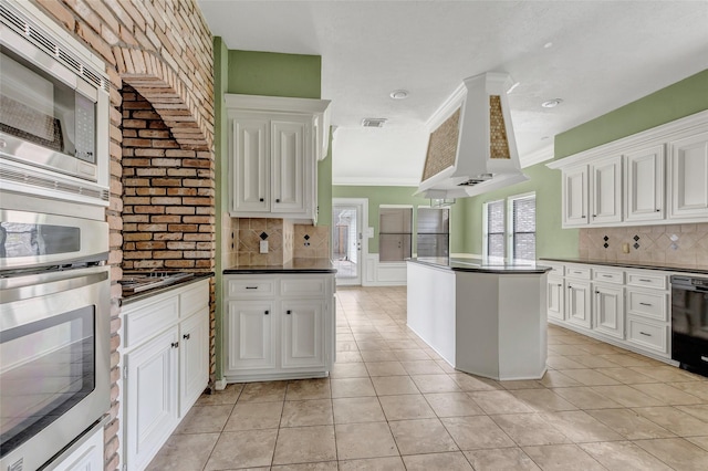 12102 Moorcreek Dr, Houston, TX 77070 - kitchen with appliances with stainless steel finishes, wall chimney exhaust hood, decorative backsplash, dark countertops, and a kitchen island