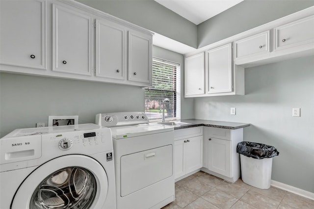 12102 Moorcreek Dr, Houston, TX 77070 - laundry area featuring washer and clothes dryer, cabinet space, and light tile patterned floors