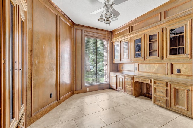 12102 Moorcreek Dr, Houston, TX 77070 - unfurnished office with ornamental molding, a ceiling fan, built in study area, light tile patterned floors, and wooden walls