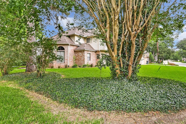 12102 Moorcreek Dr, Houston, TX 77070 - view of front facade featuring brick siding, a front yard, and a shingled roof