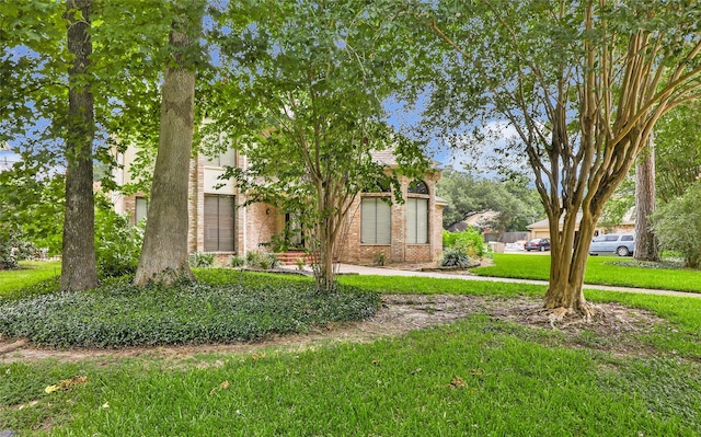 12102 Moorcreek Dr, Houston, TX 77070 - view of property hidden behind natural elements with brick siding and a front yard