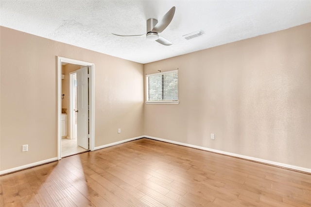 12102 Moorcreek Dr, Houston, TX 77070 - empty room with ceiling fan, wood finished floors, and a textured ceiling
