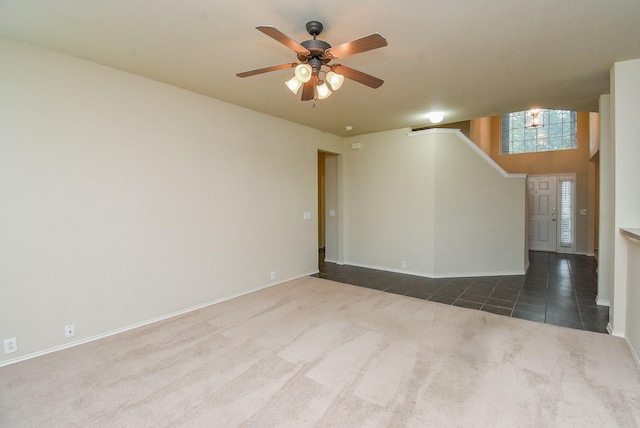 2814 Edgewick Elm St, Fresno, TX 77545 - spare room featuring dark carpet, a ceiling fan, dark tile patterned flooring, and stairs