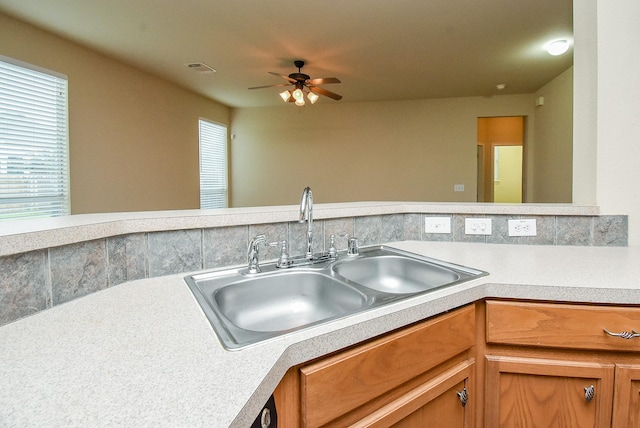 2814 Edgewick Elm St, Fresno, TX 77545 - kitchen with light countertops, ceiling fan, and brown cabinets