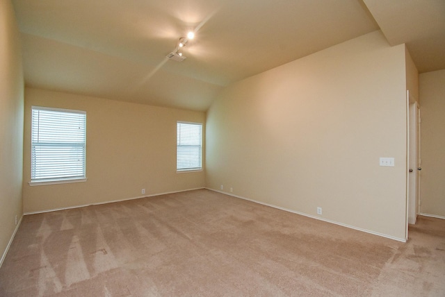 2814 Edgewick Elm St, Fresno, TX 77545 - unfurnished room with light colored carpet, rail lighting, plenty of natural light, and vaulted ceiling