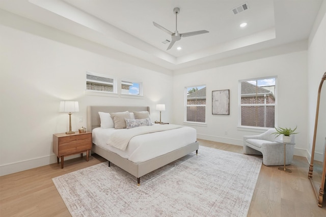 5405 Dickson St, Houston, TX 77007 - bedroom featuring light wood-style floors, a tray ceiling, recessed lighting, and ceiling fan