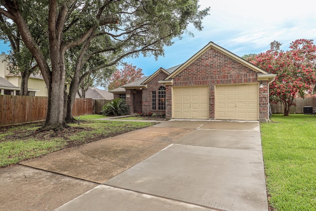 17803 Inland Oaks Dr, Richmond, TX 77407 - view of front of house featuring brick siding, an attached garage, and driveway