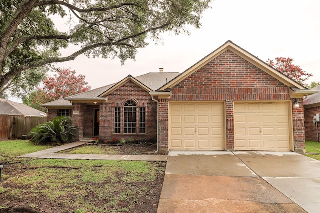 17803 Inland Oaks Dr, Richmond, TX 77407 - view of front of home featuring a garage, concrete driveway, brick siding, and roof with shingles
