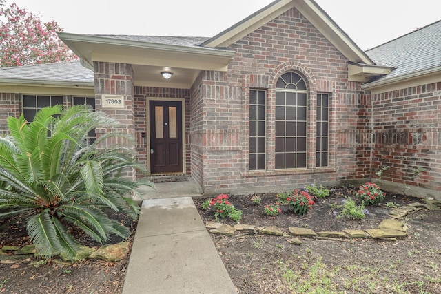 17803 Inland Oaks Dr, Richmond, TX 77407 - doorway to property with brick siding and roof with shingles