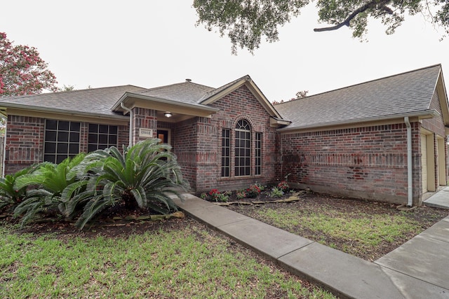 17803 Inland Oaks Dr, Richmond, TX 77407 - view of front of house featuring brick siding and roof with shingles