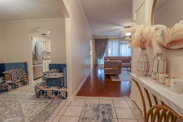 17803 Inland Oaks Dr, Richmond, TX 77407 - hallway featuring crown molding, arched walkways, and light tile patterned floors