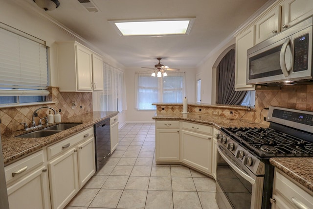 17803 Inland Oaks Dr, Richmond, TX 77407 - kitchen featuring appliances with stainless steel finishes, backsplash, light tile patterned floors, light stone counters, and ornamental molding