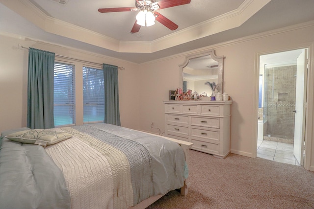 17803 Inland Oaks Dr, Richmond, TX 77407 - bedroom featuring a tray ceiling, ornamental molding, light colored carpet, ceiling fan, and ensuite bath