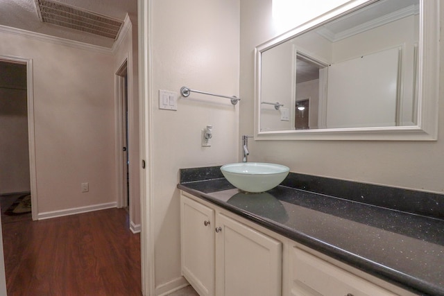 17803 Inland Oaks Dr, Richmond, TX 77407 - bathroom with ornamental molding, vanity, and wood finished floors