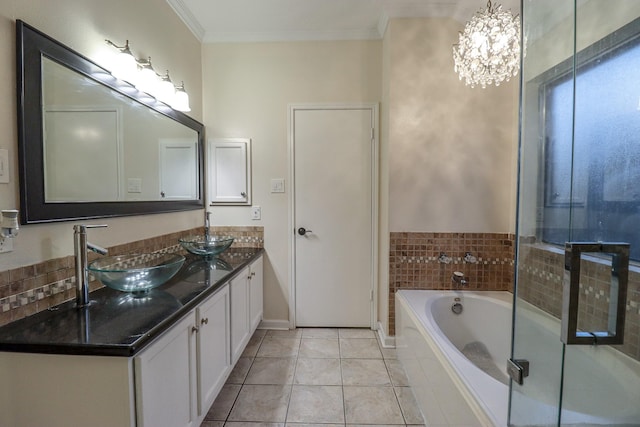 17803 Inland Oaks Dr, Richmond, TX 77407 - full bath with double vanity, crown molding, a garden tub, a chandelier, and tile patterned flooring