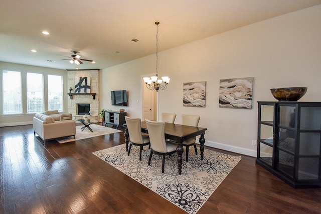 19750 Lago Terrace Loop, Richmond, TX 77407 - dining space with a ceiling fan, a fireplace, dark wood-style flooring, a chandelier, and recessed lighting