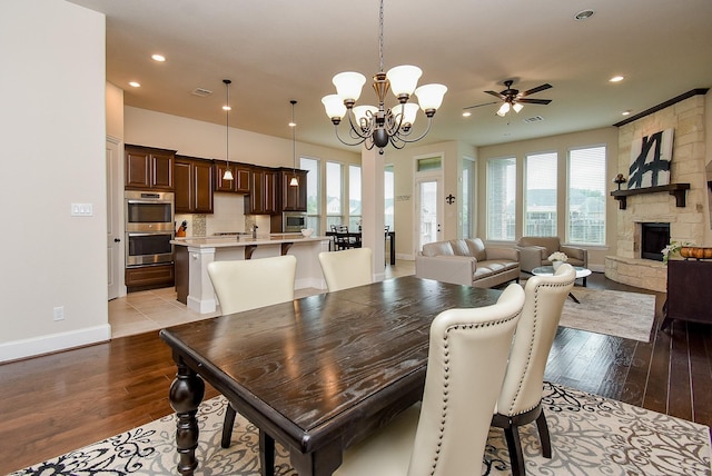 19750 Lago Terrace Loop, Richmond, TX 77407 - dining space with plenty of natural light, wood finished floors, recessed lighting, ceiling fan, and a fireplace