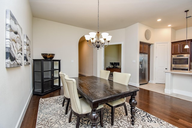 19750 Lago Terrace Loop, Richmond, TX 77407 - dining room with a chandelier, light wood-type flooring, arched walkways, and recessed lighting