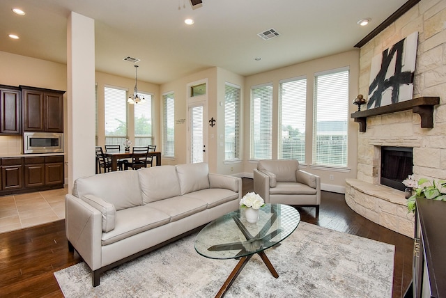 19750 Lago Terrace Loop, Richmond, TX 77407 - living room with a chandelier, dark wood-style floors, a stone fireplace, and recessed lighting