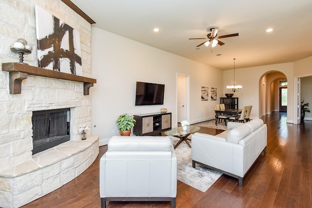 19750 Lago Terrace Loop, Richmond, TX 77407 - living area featuring arched walkways, ceiling fan, wood finished floors, a fireplace, and recessed lighting