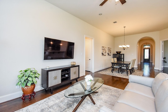 19750 Lago Terrace Loop, Richmond, TX 77407 - living area featuring arched walkways, ceiling fan, wood finished floors, and a chandelier