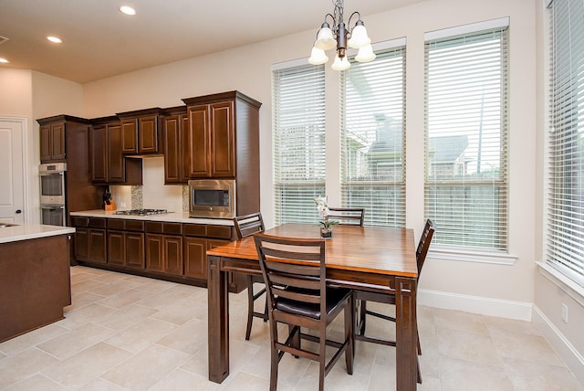 19750 Lago Terrace Loop, Richmond, TX 77407 - kitchen featuring appliances with stainless steel finishes, light countertops, a chandelier, dark brown cabinetry, and recessed lighting
