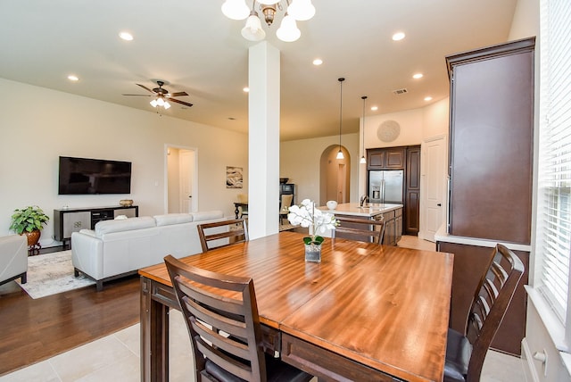 19750 Lago Terrace Loop, Richmond, TX 77407 - dining room featuring ceiling fan, arched walkways, a chandelier, recessed lighting, and light tile patterned flooring
