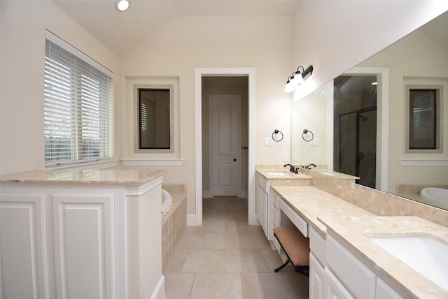 19750 Lago Terrace Loop, Richmond, TX 77407 - full bathroom featuring a shower stall, a bath, lofted ceiling, double vanity, and tile patterned floors