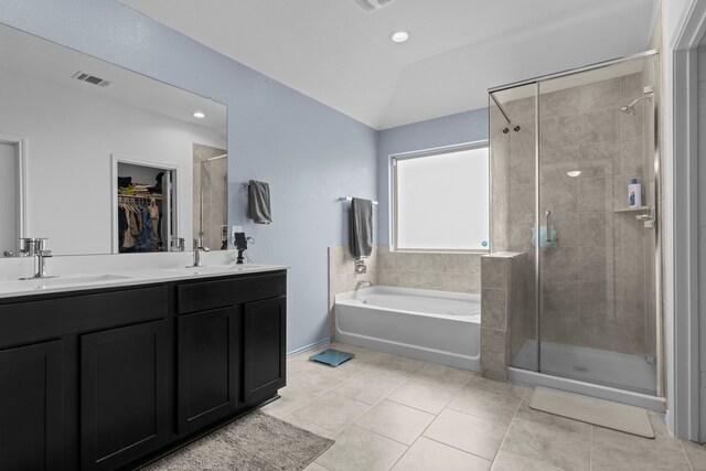 14205 Dream Rd, New Caney, TX 77357 - bathroom featuring a shower stall, a bath, lofted ceiling, double vanity, and tile patterned flooring