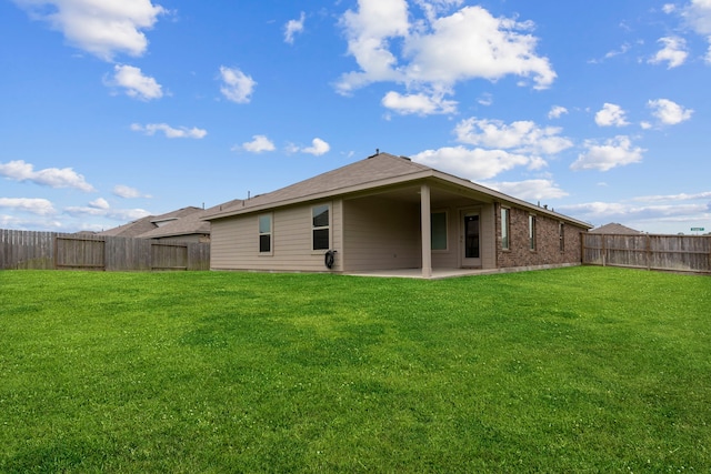 14205 Dream Rd, New Caney, TX 77357 - rear view of house with a patio, a fenced backyard, and brick siding