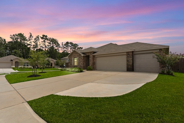 14205 Dream Rd, New Caney, TX 77357 - view of front of property featuring driveway, a garage, a lawn, and brick siding