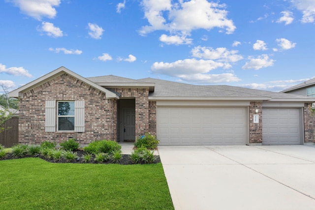14205 Dream Rd, New Caney, TX 77357 - view of front of house featuring brick siding, a garage, driveway, and a front yard