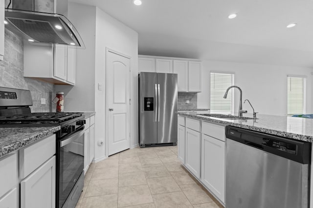 14205 Dream Rd, New Caney, TX 77357 - kitchen featuring stainless steel appliances, ventilation hood, healthy amount of natural light, tasteful backsplash, and recessed lighting